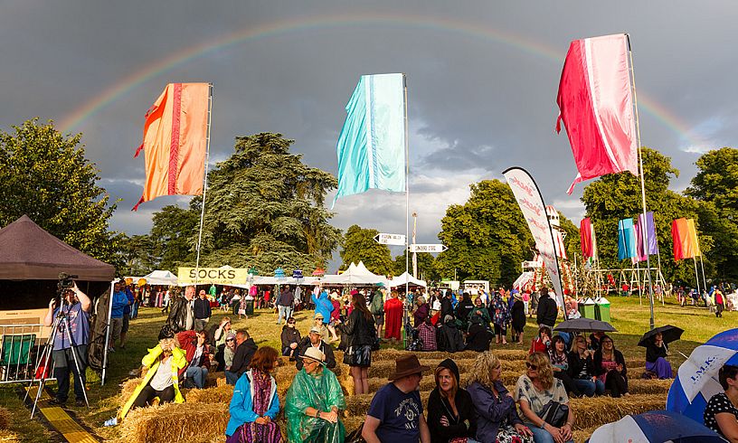 The rainbow of colours created by Cornbury fans is matched perfectly by the real thing at the 2014 festival.